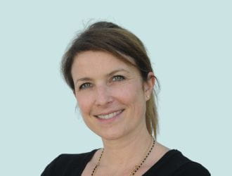 Portrait of Héloïse AUBERT, a smiling, professional member of the communications team.