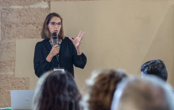  an acteos speaker on stage during a workshop. 