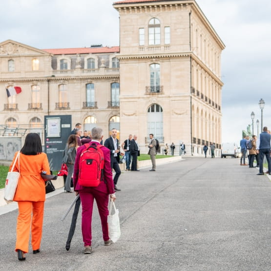 Top Transport Europe 2023 participants walk towards the Palais du Pharo in Marseille.